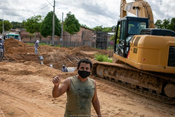 Juarez Ribeiro faz sinal de positivo em frente a obra de drenagem. Infraestrutura e asfalto no Araceli